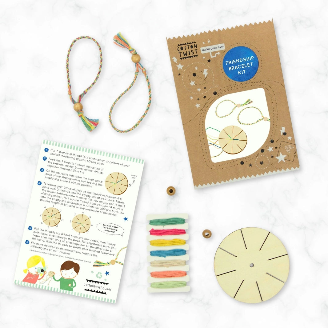 flat-lay of the Cotton Twist make your own friendship bracelet kit with contents and gift packaging on a marble surface