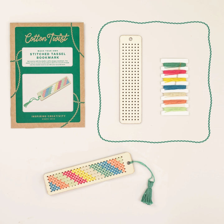 Colourful embroidered bookmark with tassel, perforated sheet, and packaging on a light background