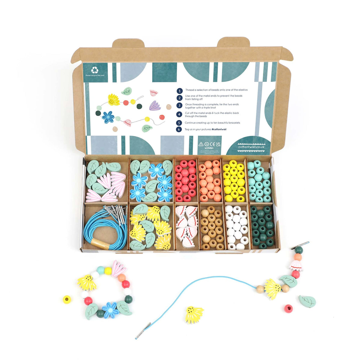 Cotton Twist Wildflower Bracelet Making Kit: Open box with colourful nature inspired beads, elastic cords, and finished bracelets.