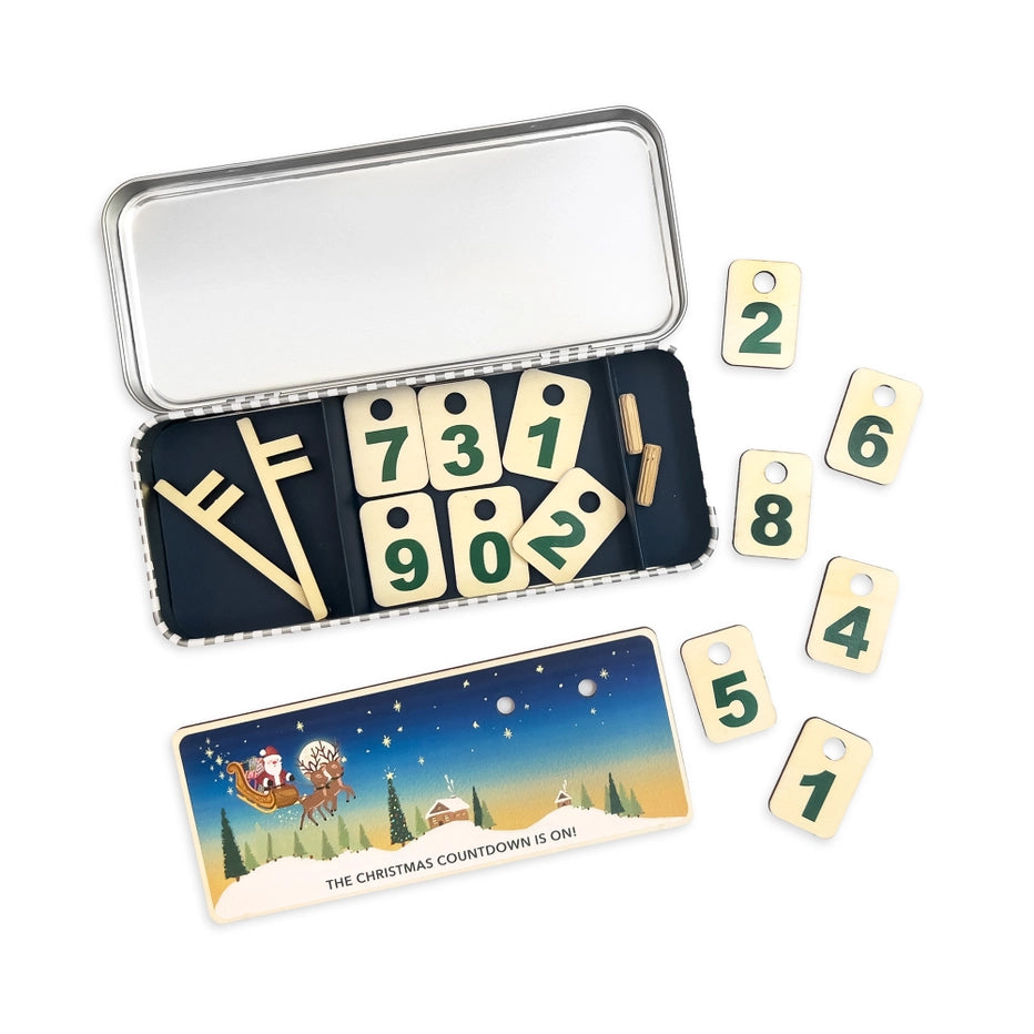 children's Christmas calendar with numbered tokens inside a gift tin 