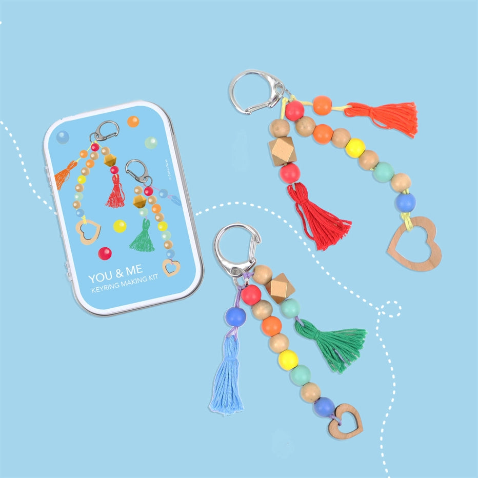 Colourful keychains with beads and tassels on a blue background
