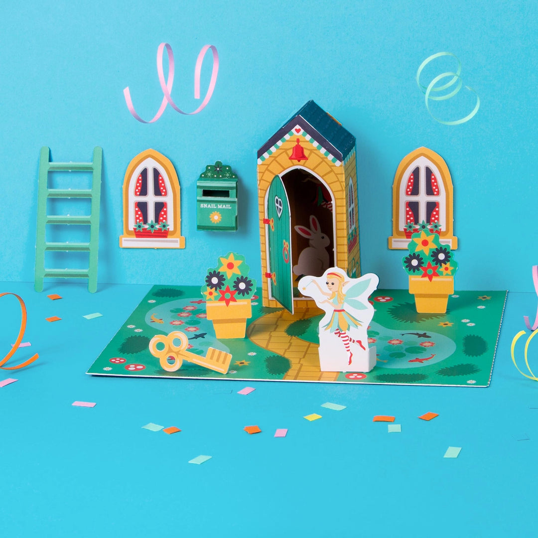 Fairy door set with fairy figure, key, and decorative elements on a blue background