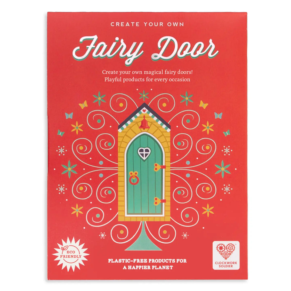A red product box for a 'Fairy Door' craft kit, featuring a colorful illustration of a green fairy door surrounded by whimsical swirls and stars. The packaging includes text such as 'Create your own Fairy Door' and 'Plastic-free products for a happier planet,' along with a 'Clockwork Dreamer' logo.