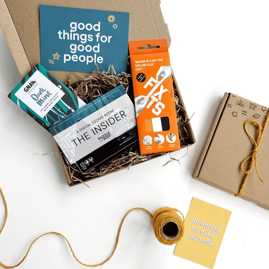 dads night in letter box gift set with fix its sticks, dark mint chocolate and a digital escape room game. The products are inside a kraft gift box with shredded paper and stamped details.