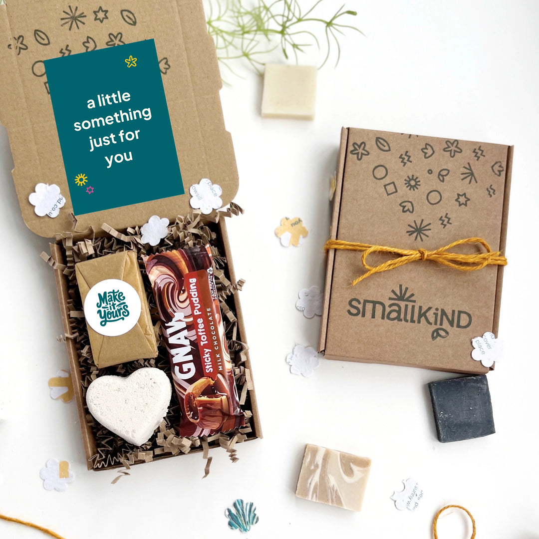 Small gift Bespoke Corporate Gift box with luxury self care products including bath bomb, cleansing bar and a chocolate bar. There is a 'little something for you' gift card inside the hand stamped gift box. 