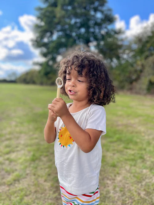 child blowing bubbles from the Dr Zigs Mini Bubble Kit