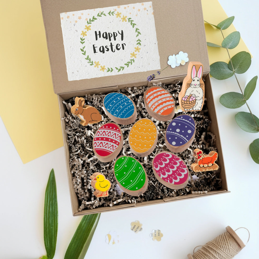 Easter themed gift box for children with wooden eggs, bunny, chick and hen play figures and a Happy Easter card.