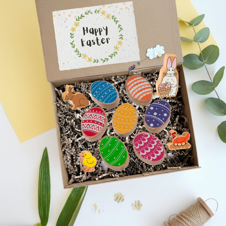 Easter themed gift box for children with wooden eggs, bunny, chick and hen play figures and a Happy Easter card.