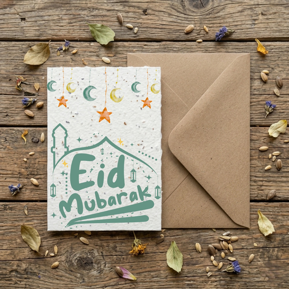 Eid Mubarak card with envelope on a wooden surface with decorative elements.