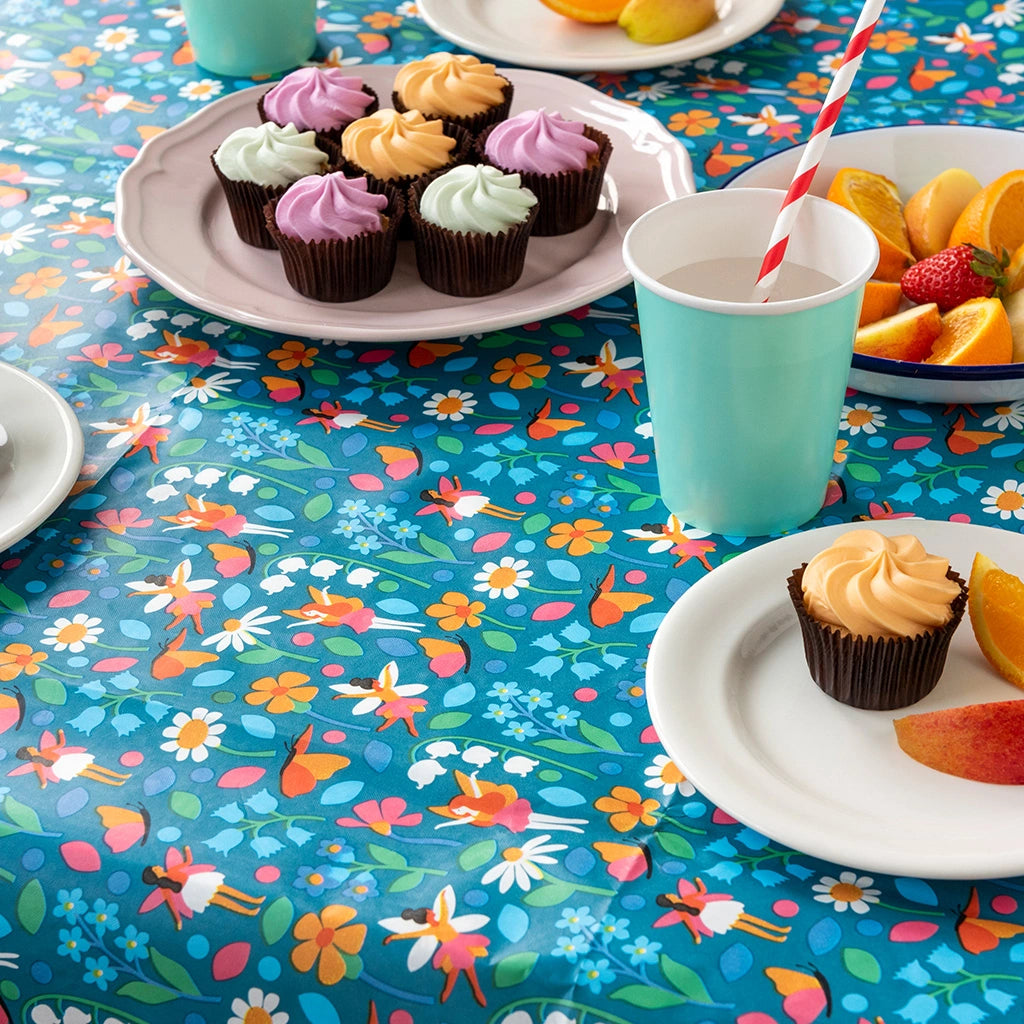 blue fairies in the garden table cloth on a party table with cakes and drinks. Plastic free and recyclable. 