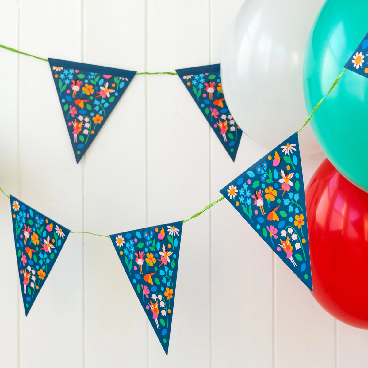 fairies in the Garden reusable card and paper party bunting strung up with colourful balloons. Perfect for kids parties and nursery decor. 