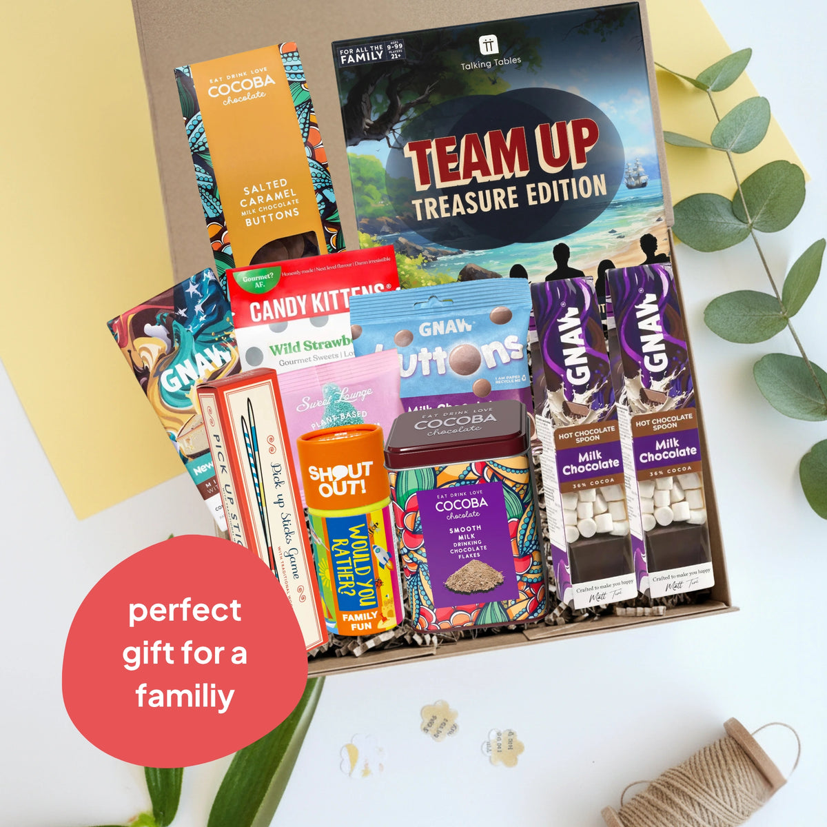 Assorted family games, chocolates and sweets in a gift box