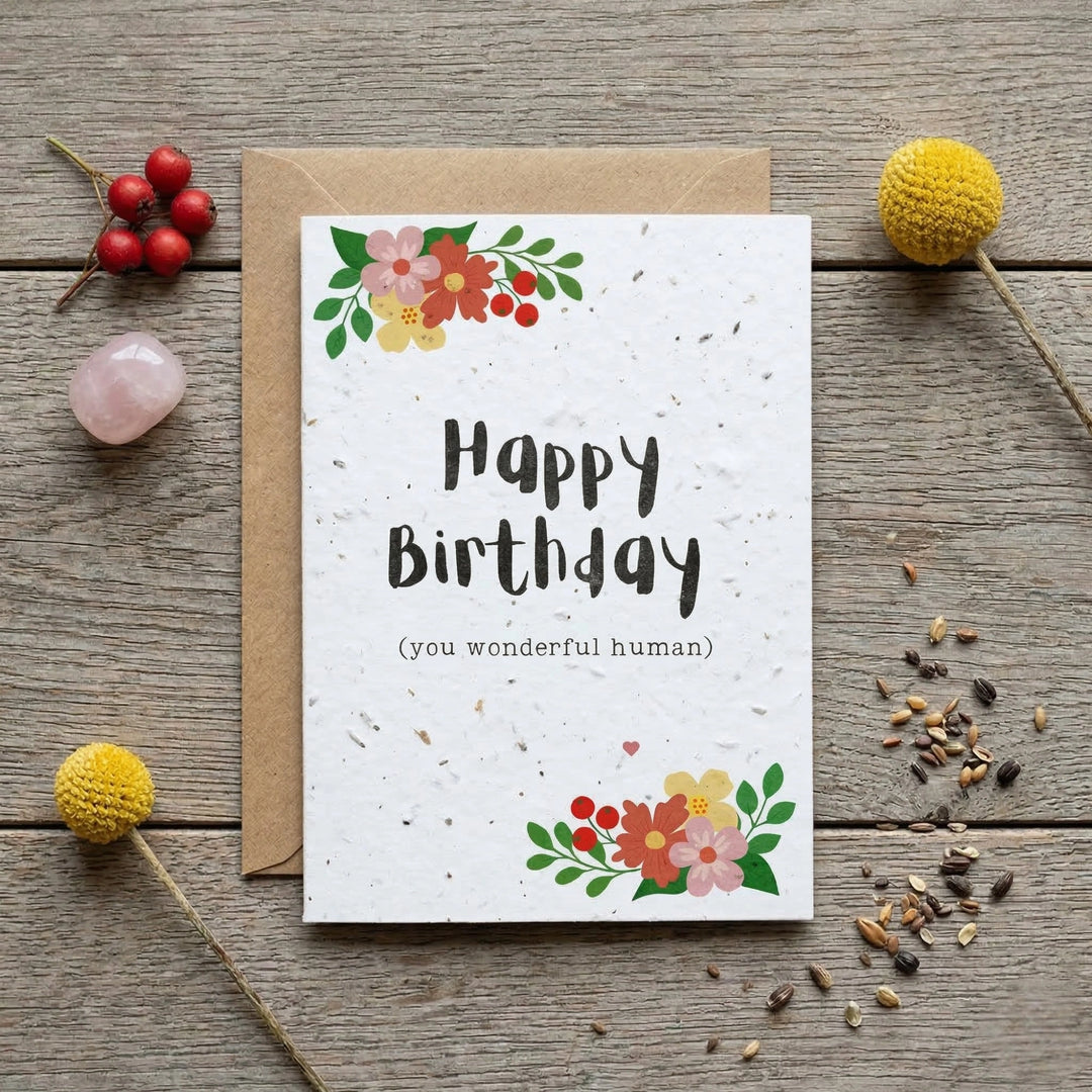 happy birthday plantable seed card with colourful floral design and a kraft paper envelope