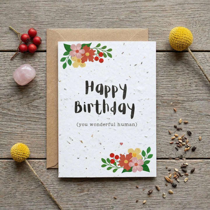 happy birthday plantable seed card with colourful floral design and a kraft paper envelope