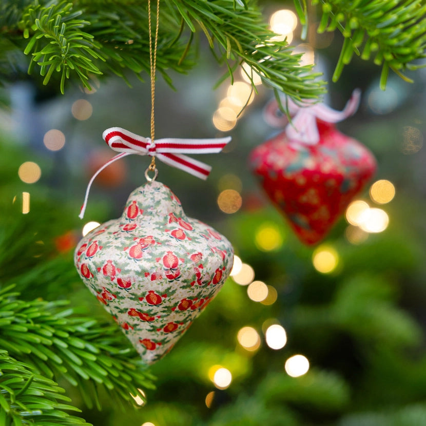 two teardrop shaped Christmas decorations hung on a Christmas tree