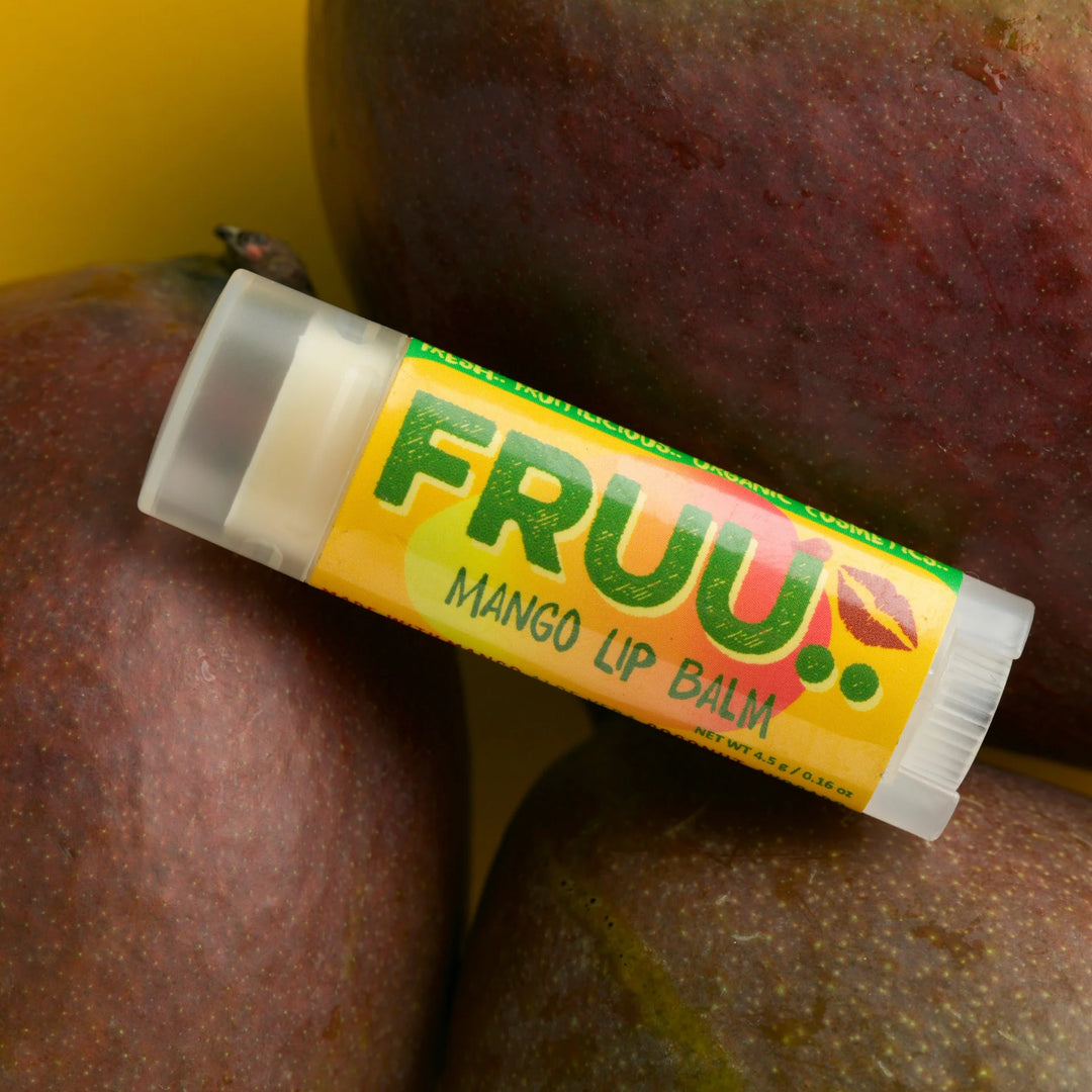 Fruu Mango Lip balm with yellow label on a mango background