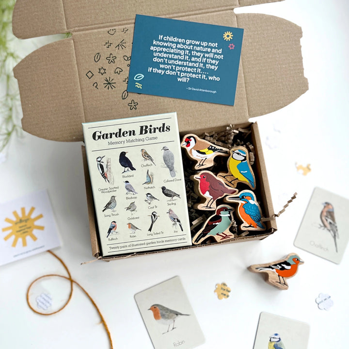 Garden Birds memory matching game set with cards and wooden birds play figures in a gift box on a white background