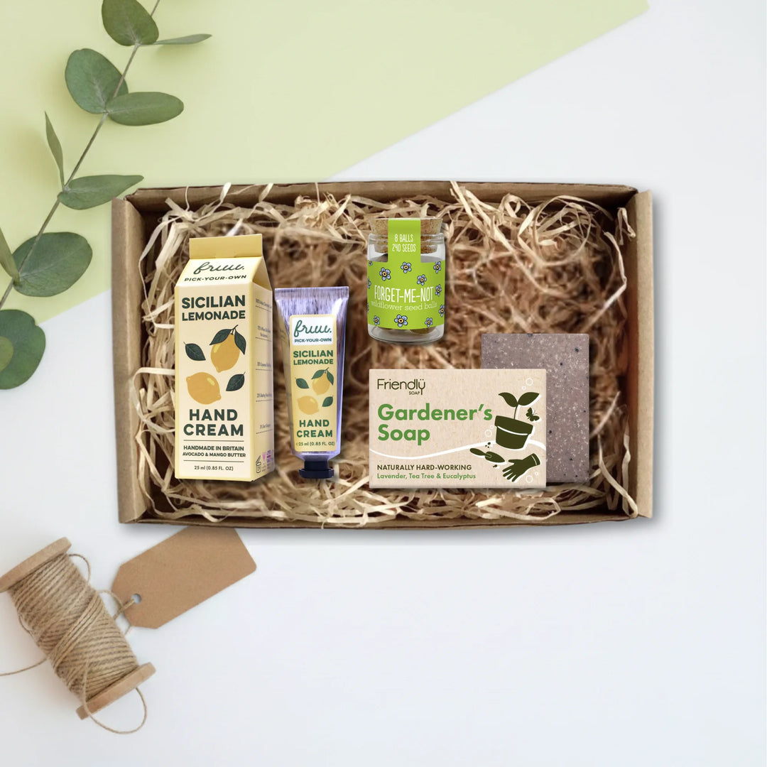 A curated gift box set containing a box of Greenery Sicilian Lemonade hand cream, a tube of Palm hand cream, a bottle of Freshly Picked hand cream, and a bar of Friendly Gardener&