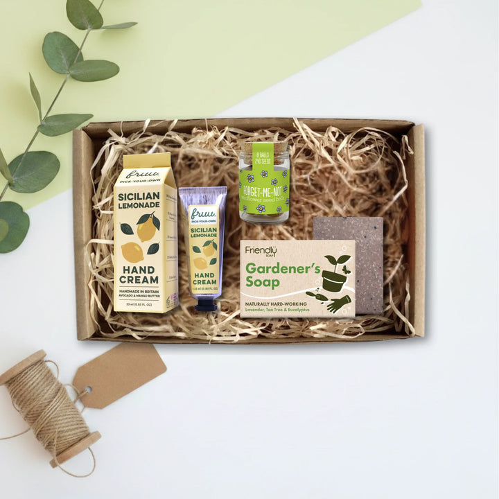 A curated gift box set containing a box of Greenery Sicilian Lemonade hand cream, a tube of Palm hand cream, a bottle of Freshly Picked hand cream, and a bar of Friendly Gardener&