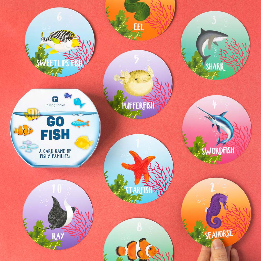 Set of ocean-themed playing cards with colourful illustrations on a red background