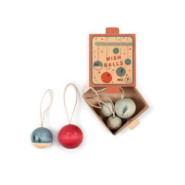 Set of three colourful wish balls Christmas decorations with a decorative keepsake box on a white background