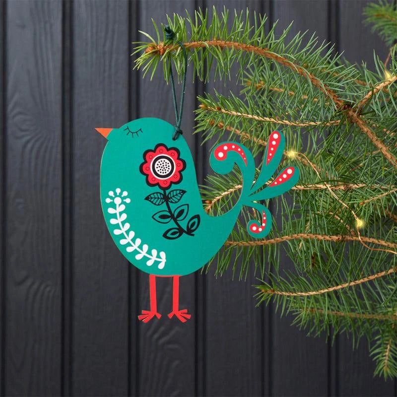 Green Wooden Bird Christmas Tree Decoration with scandi style painted details. The decoration is hung on a green Christmas tree. 