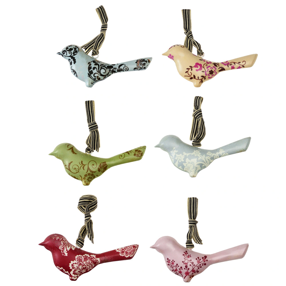Set of decorative bird ornaments with floral patterns on a white background