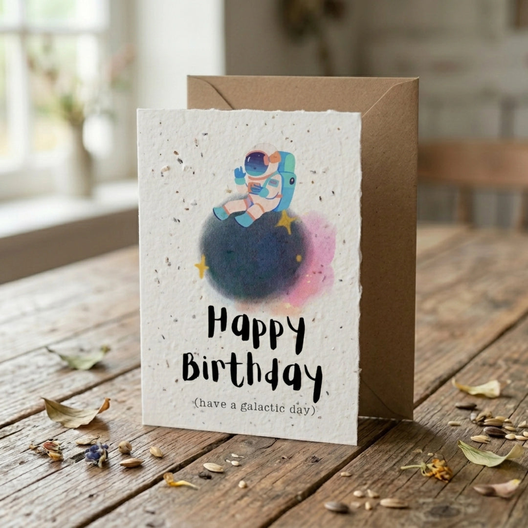 Birthday card with space-themed illustration on a wooden table