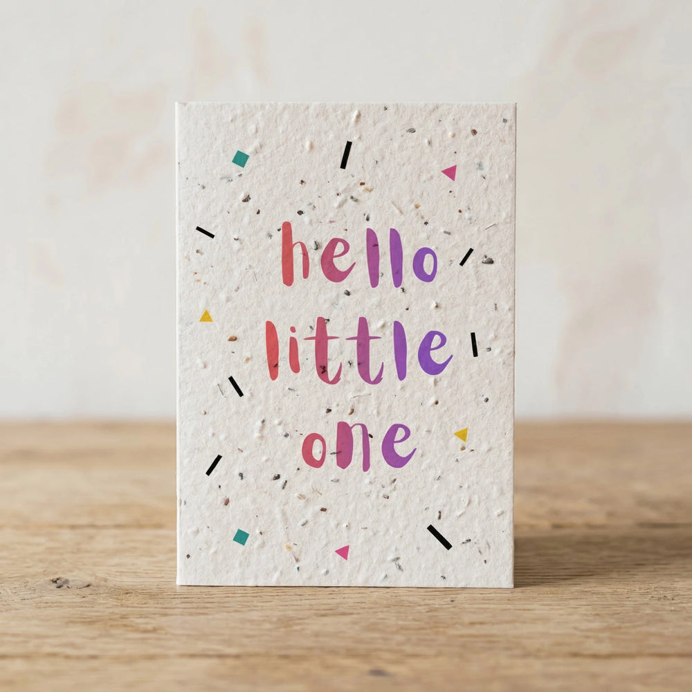 Greeting card with 'hello little one' text on a wooden surface