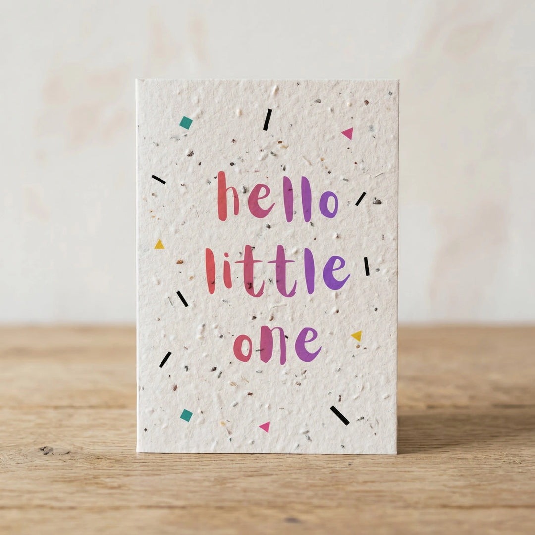 Greeting card with 'hello little one' text on a wooden surface