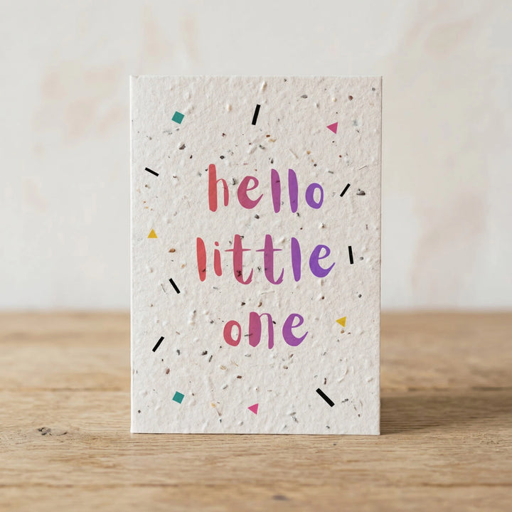Greeting card with 'hello little one' text on a wooden surface