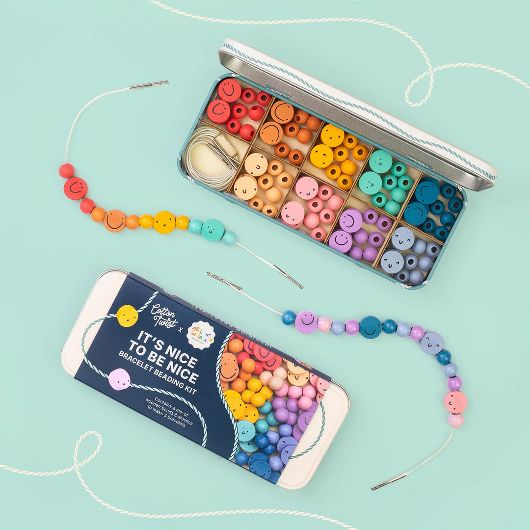 Colorful beading kit with beads and packaging on a light blue background