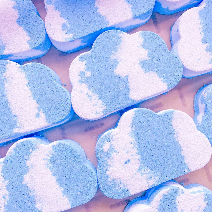 jumbo cloud bath bombs with blue and white color pattern on a reflective surface