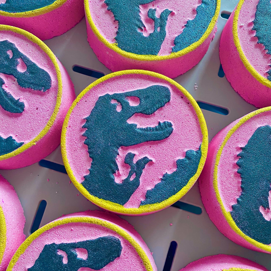 close up of a bright pink jurassic dinosaur bath bomb