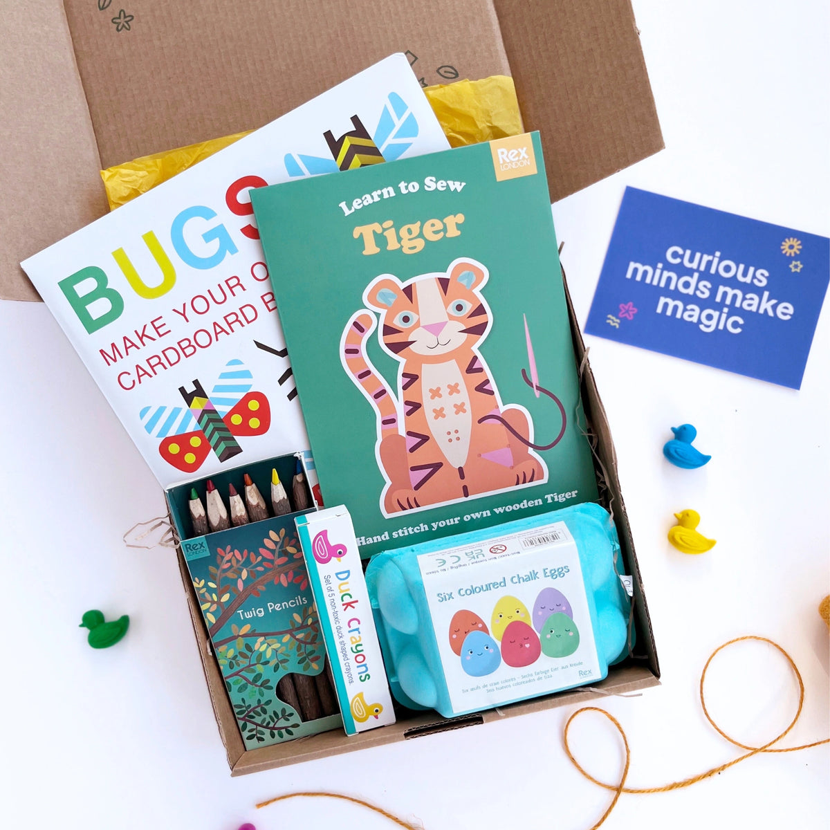 Hand-stamped gift box with yellow twine, containing the Wild Creature Craft Box with animal-themed crafts for kids.