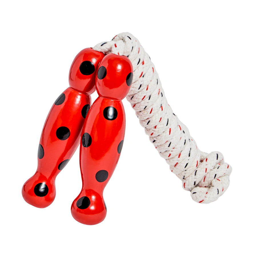 Red jump rope with black polka dots on a white background