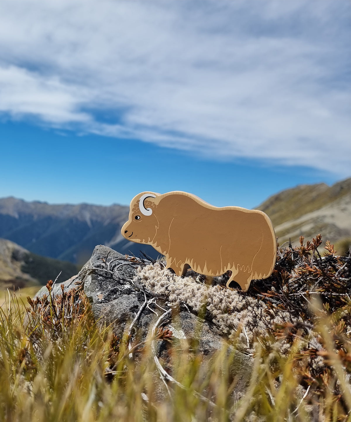 lanka kade brown wooden yak toy with a countryside backdrop 