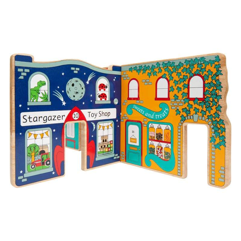 A colourful Lanka Kade Town Toy World play set made from rubber wood, featuring various shops and a bus station, with a dinosaur in the toy shop.