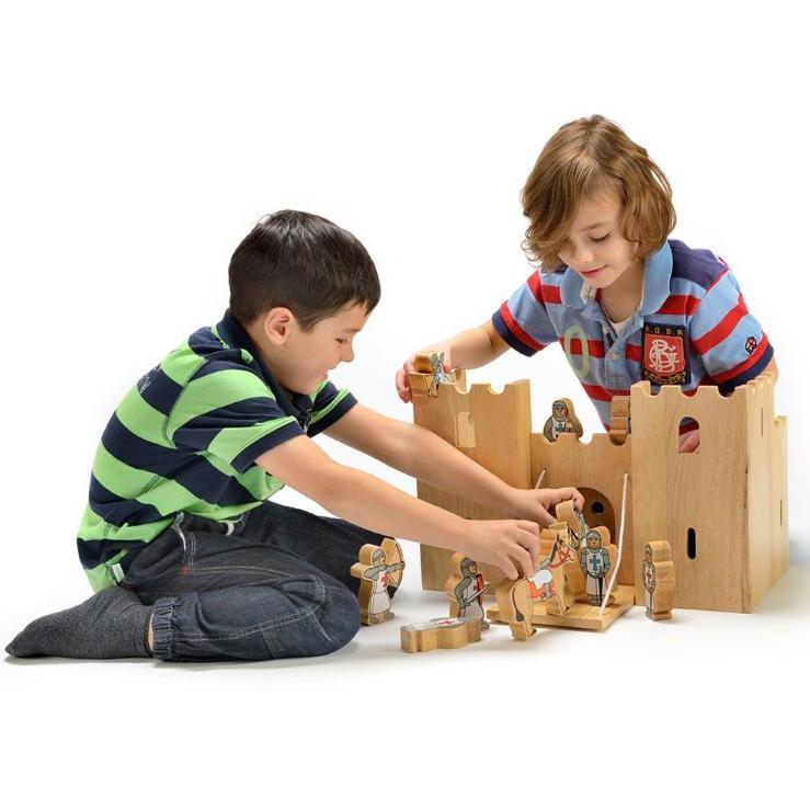 two boys playing with a wooden castle and knights made by Lanka Kade 