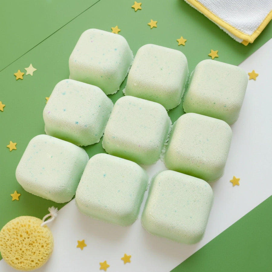 Green shower steamers on a green and white background with star decorations