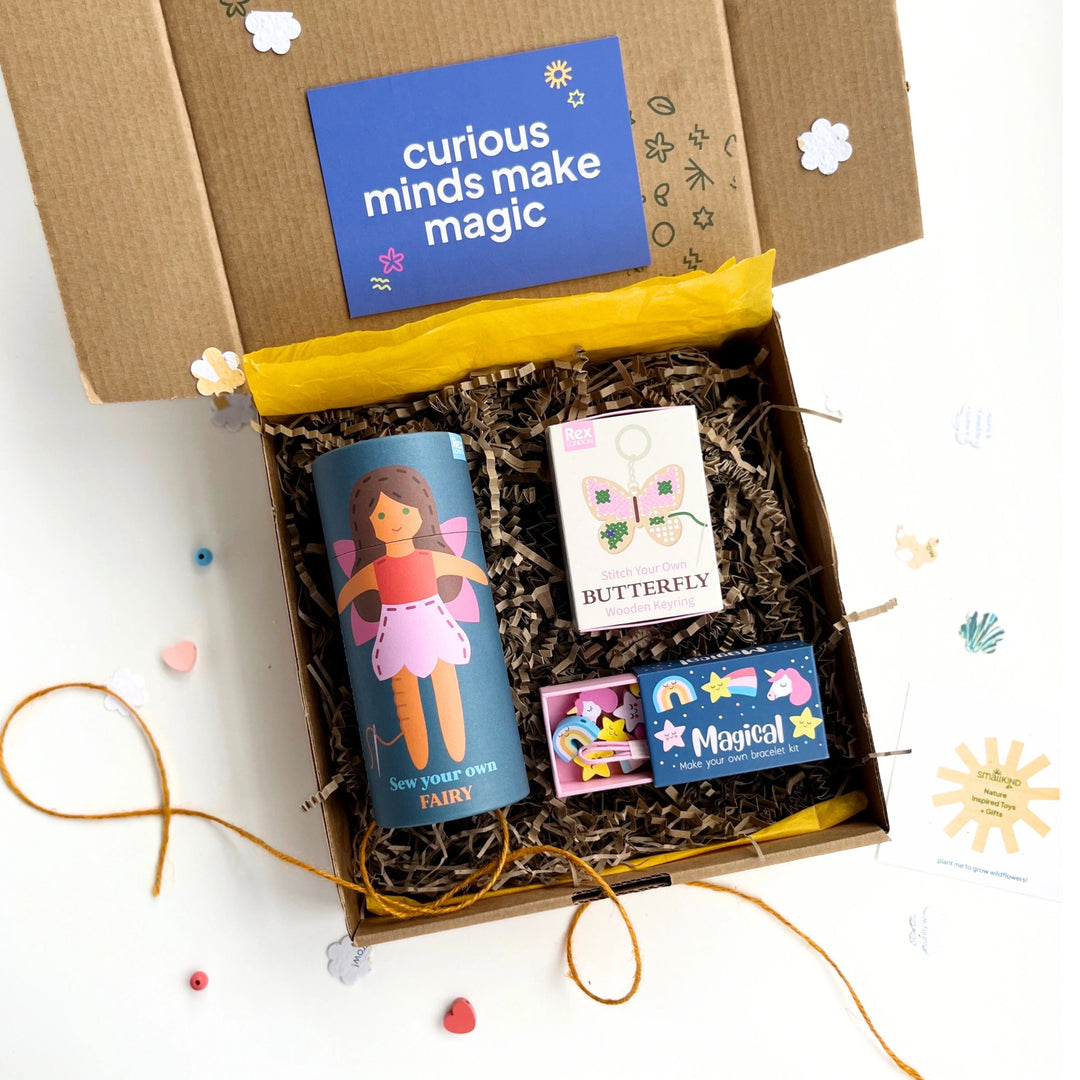 Children's craft gift box with fairy and unicorn themed sewing stitching and jewellery making craft projects in a box on a white background