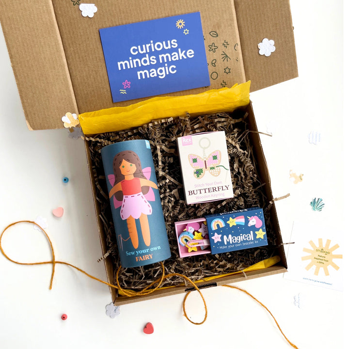 Children's craft gift box with fairy and unicorn themed sewing stitching and jewellery making craft projects in a box on a white background