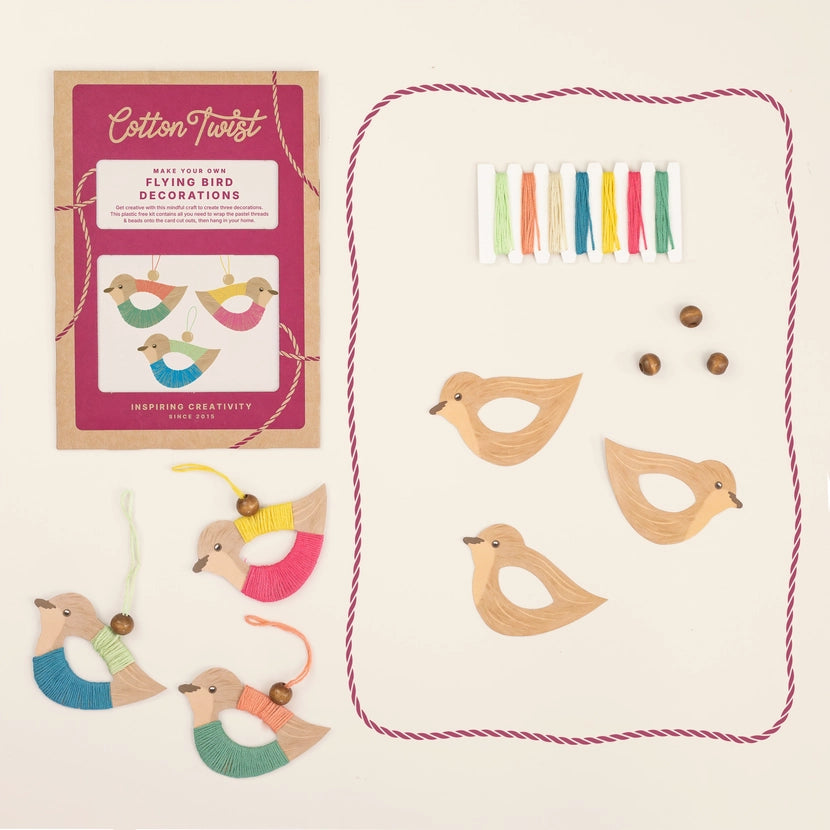 Overhead view of the Cotton Twist make your own flying birds kit with kit contents, finished birds, gift packaging and instructions.