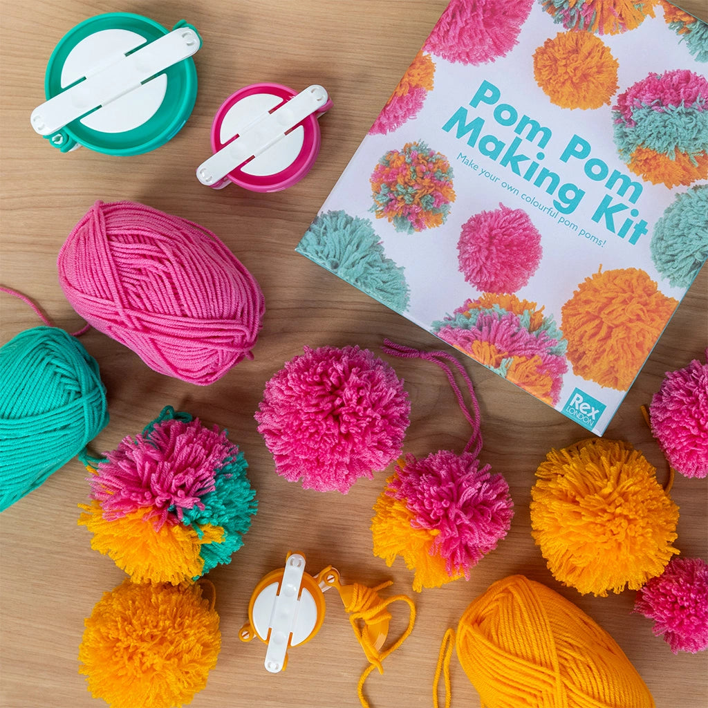 colourful pom poms and materials from a make your own pom pom kit