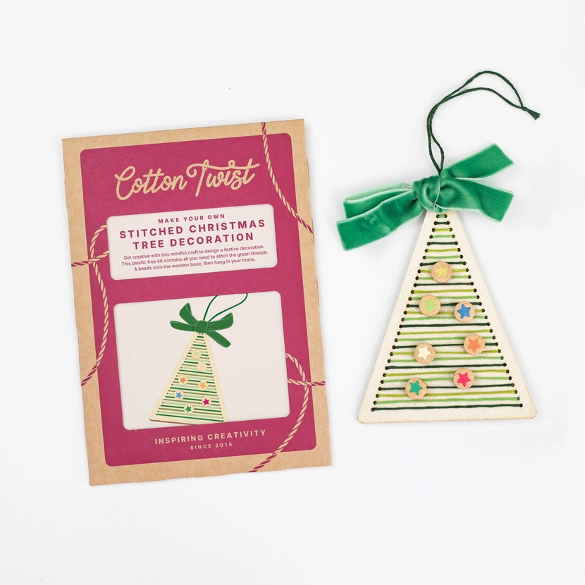 Cotton Twist stitched Christmas tree decoration kit with a completed ornament on a white background