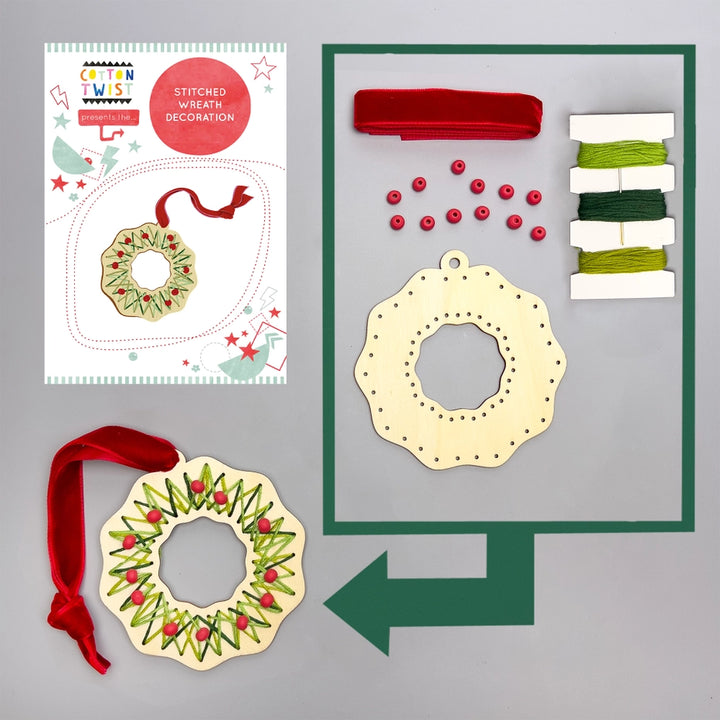 Christmas wreath decoration kit with materials on a gray background
