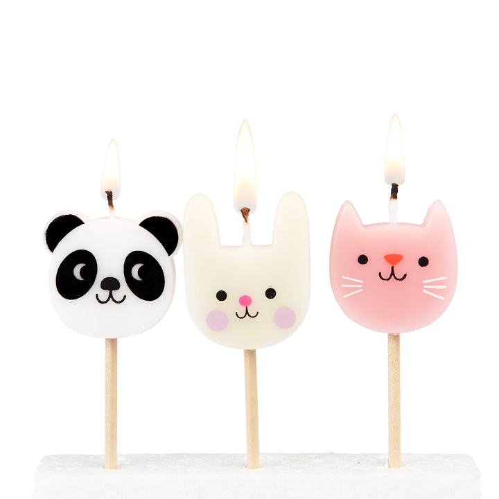 Three animal-themed candles on sticks with panda, rabbit, and cat designs against a white background.