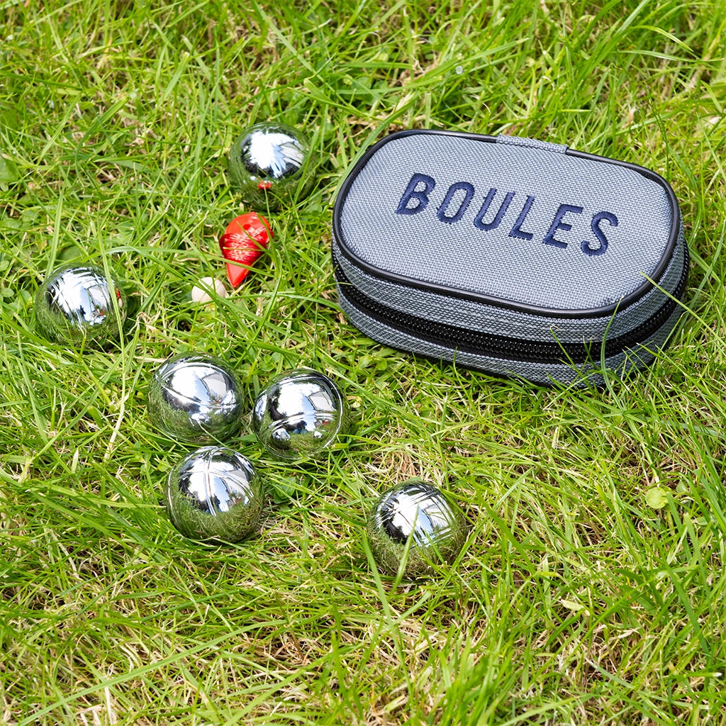 Rex London Mini Boules Set in a travel case on a lawn. For children age 3+