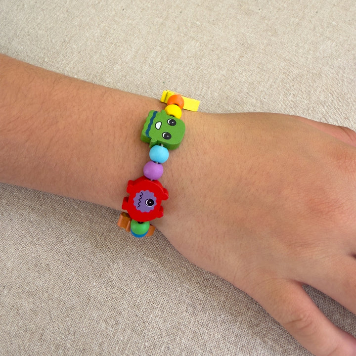 Colourful beaded bracelet on a wrist against a beige background