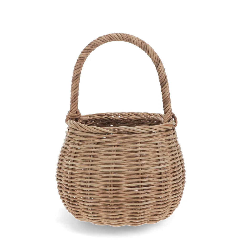 A small round woven wicker basket handbag with a single twisted handle, shown on a clean white background.